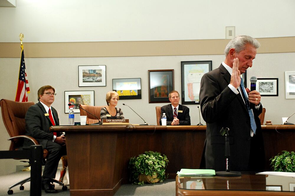 Ron Mitchell, right, takes the oath of office for the Jefferson County school board in 2015.