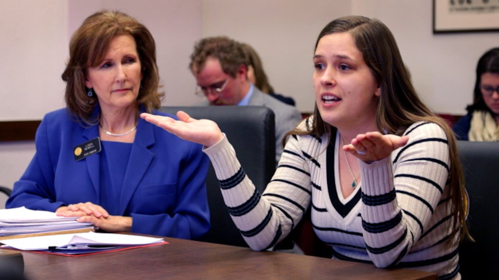 Colorado state Sen. Linda Newell, left, listens to Tori Black, a former foster child, testify at the Colorado state Senate's Finance Committee in favor of the "Fostering Connections" bill sponsored by Newell on Feb. 24, 2015. The bill failed to move out of the committee, 3-2.