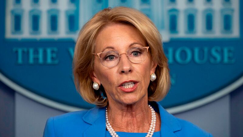 Photo of Betsy DeVos in pearls and blue shirt