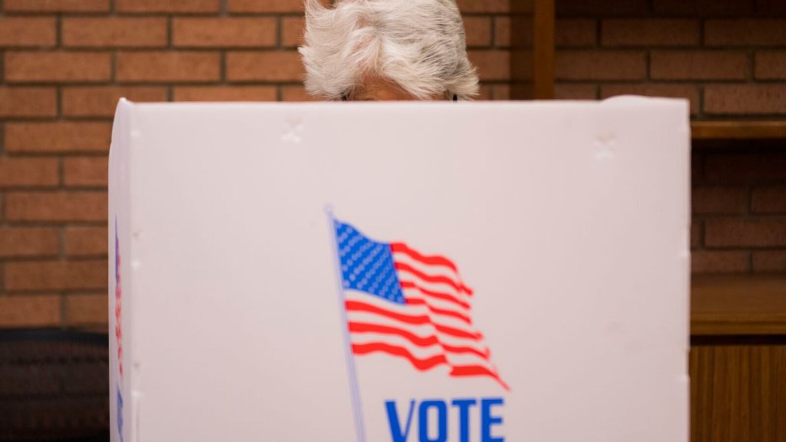 A woman casts her ballot in the voting booth at the Kent County Public Library in Chestertown, Maryland, on October 25, 2018, during Maryland early voting. (Photo by Jim WATSON / AFP)