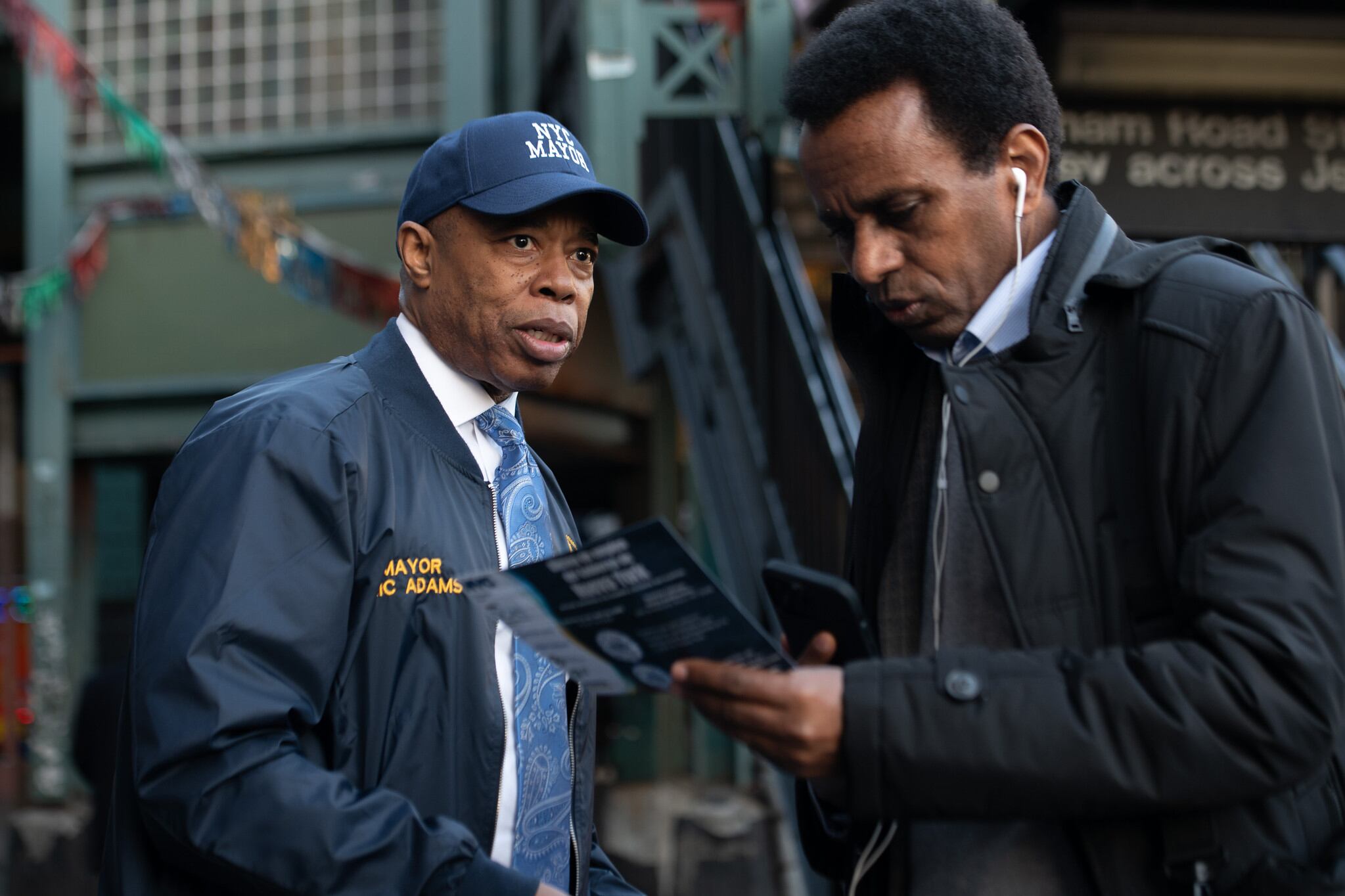 Mayor Eric Adams distributes flyers for an upcoming NYC government hiring hall event in Fordham Heights, Bronx on Wednesday, April 19, 2023.