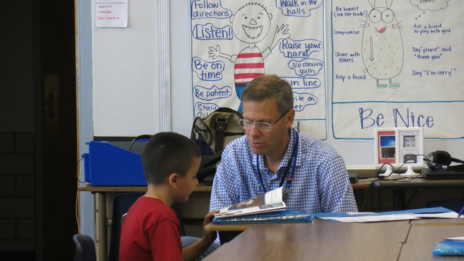 DPS superintendent Tom Boasberg reads with a student at an event called Power Lunch.