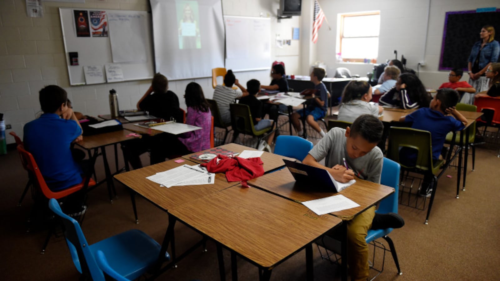 Students in Alicia Marquez's 6th grade science class at Overland Trail Middle School in Brighton watch a video and work on home work in August 2017. (Photo by Seth McConnell/The Denver Post)
