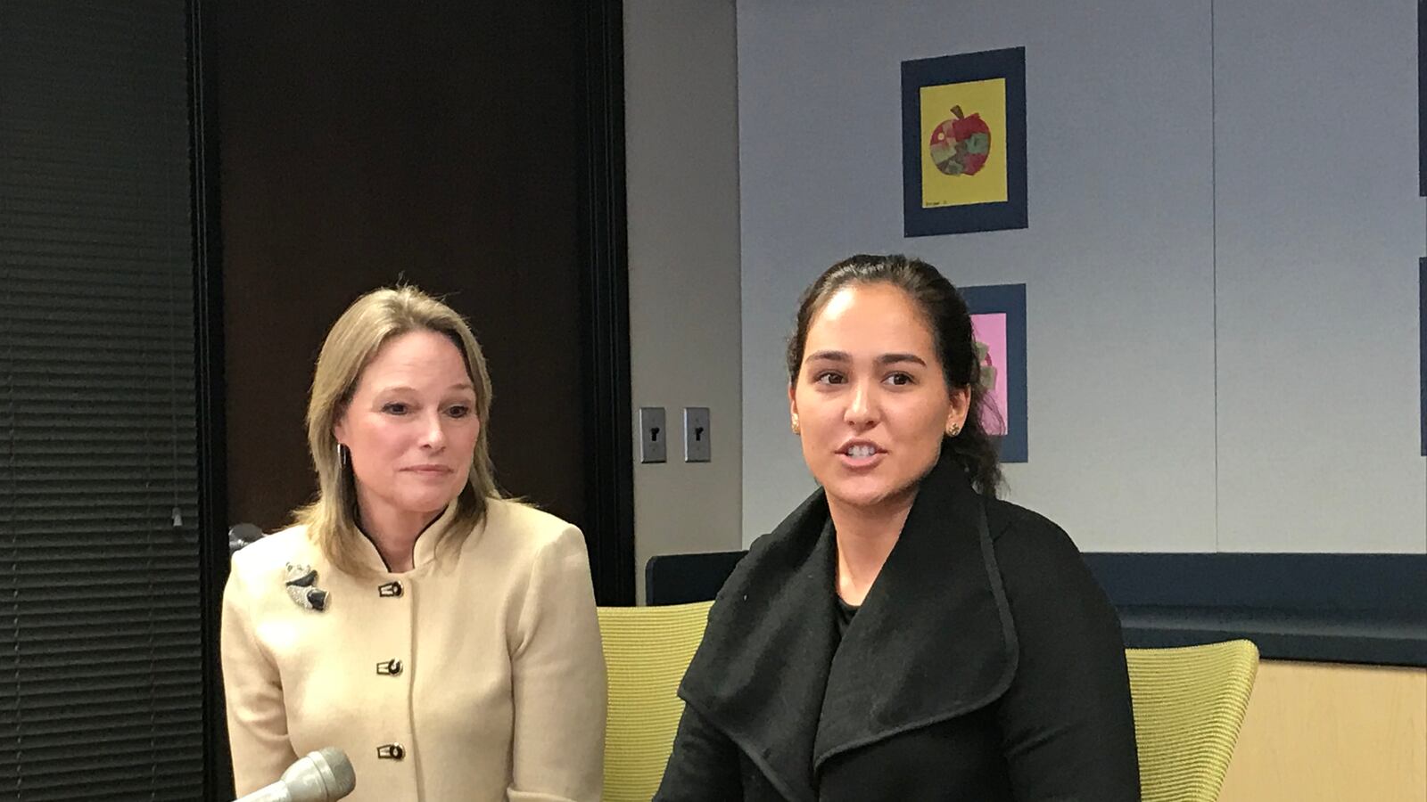 Karen Pastor, left, a veteran Detroit teacher, sits with Samantha Ciaffone during a news conference Wednesday. Pastor is mentoring Ciaffone through a new program in the Detroit Public Schools Community District.