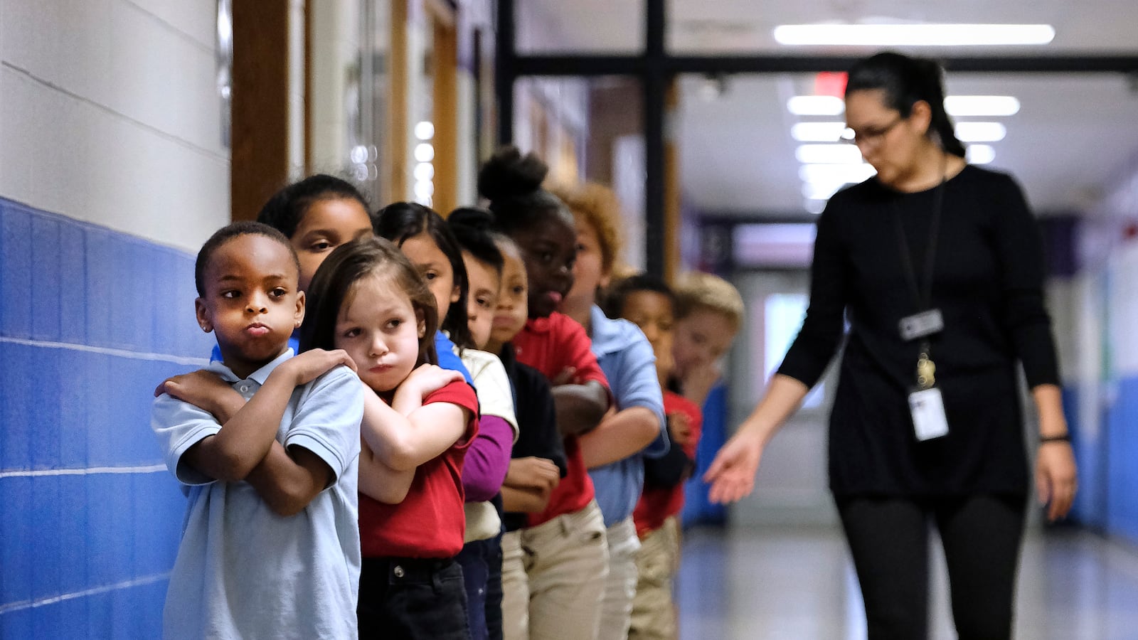 Students in a line in a hallway at Thomas Gregg Neighborhood School, an elementary school in Indianapolis, Indiana. —April, 2019— Photo by Alan Petersime/Chalkbeat