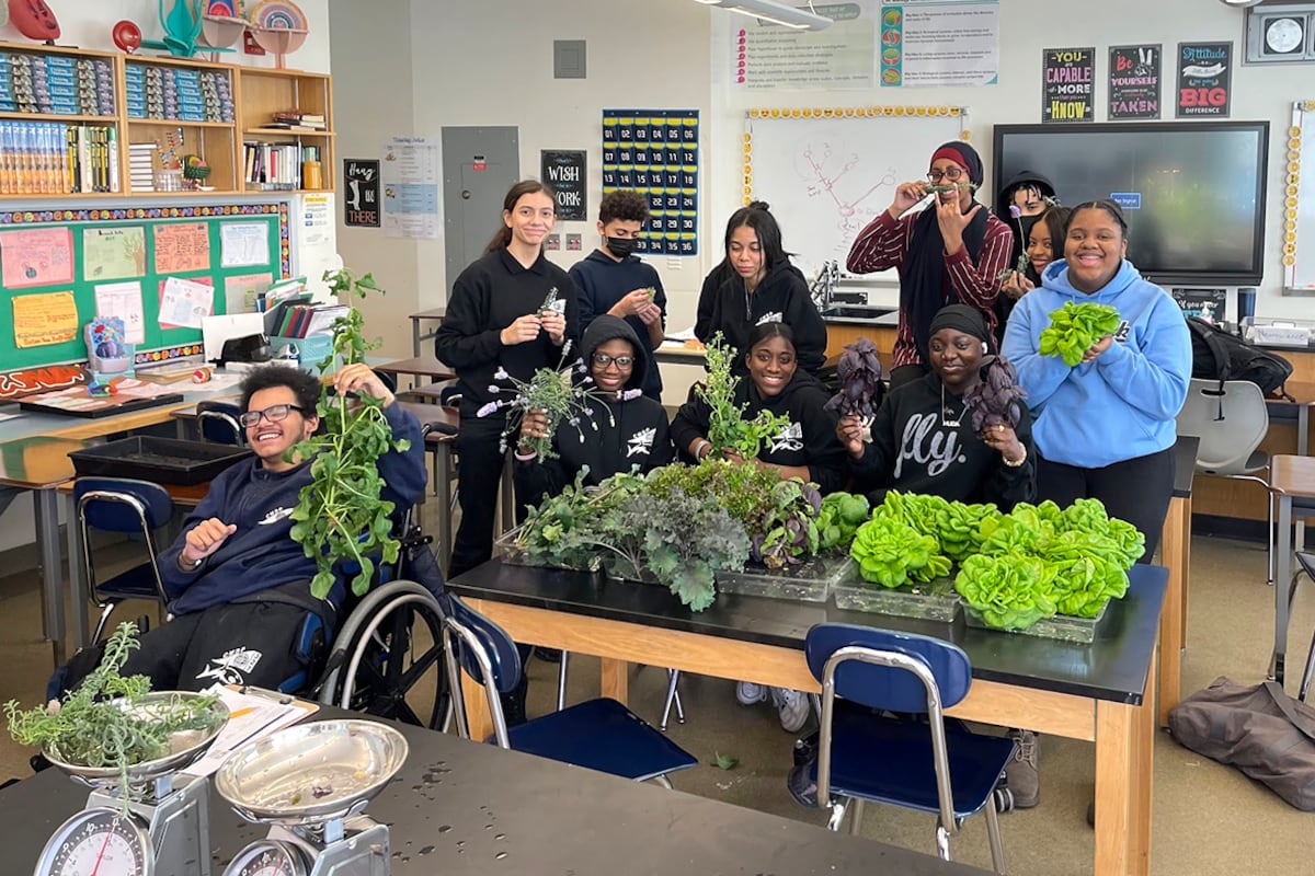A group of students together in a classroom.
