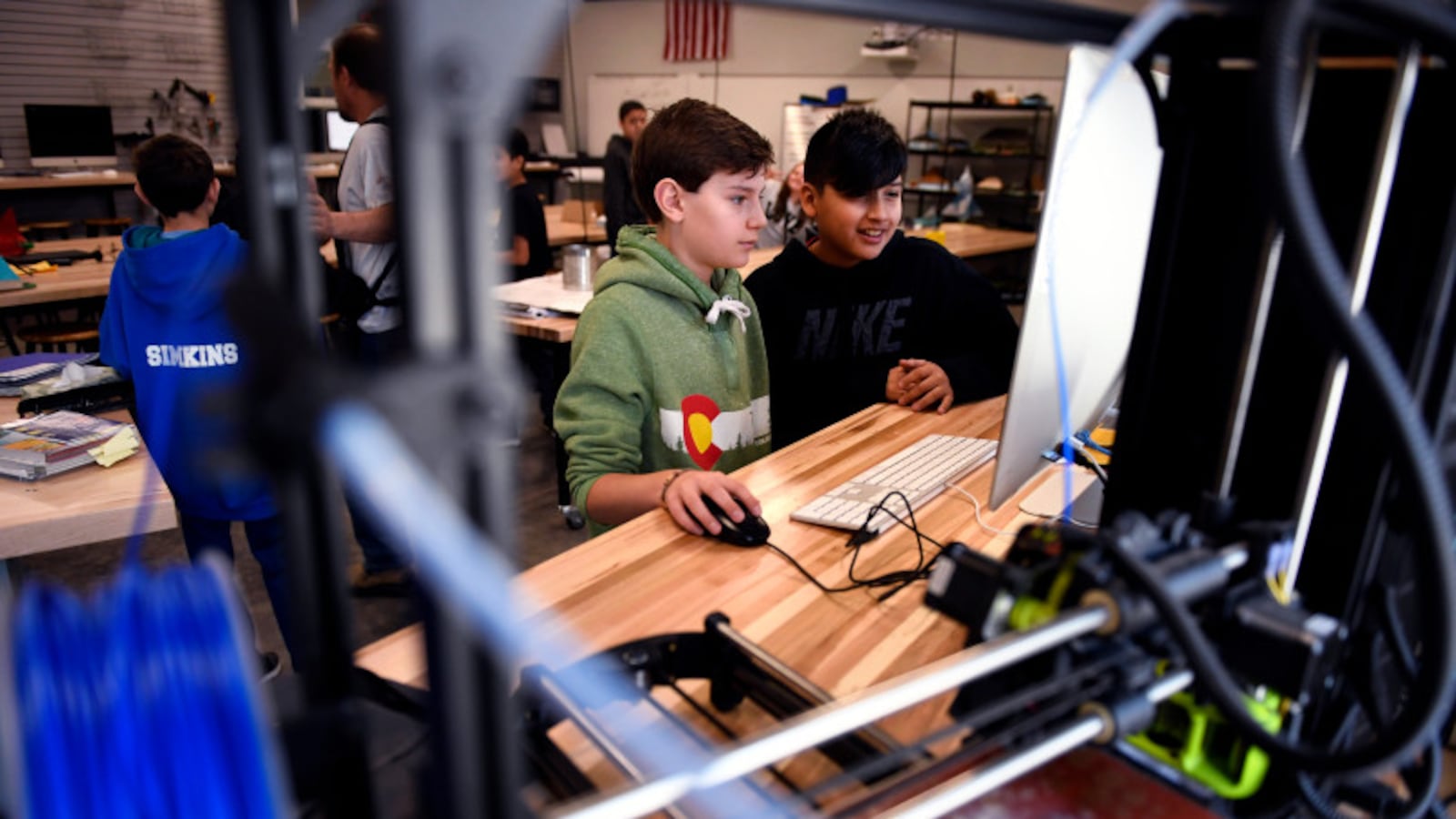 Seventh-graders Caden Kay and Santana Hernandez work with the 3D printer at Columbine Middle School in Montrose, Colorado.