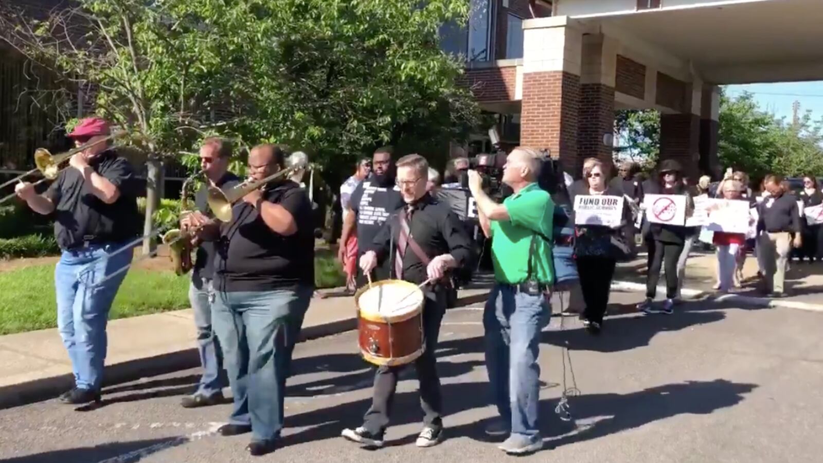 Voucher opponents march Monday to the state Capitol from the Nashville headquarters of the Tennessee Education Association in a mock funeral to protest Gov. Bill Lee's education savings account bill.