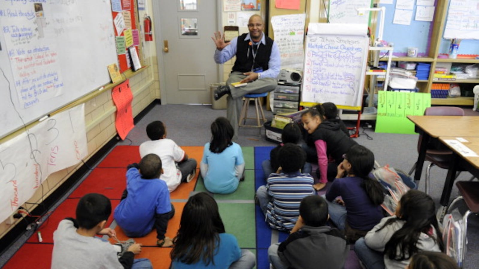 Ashley Elementary School third-grade teacher Tyrone Johnson works with his students in this 2011 photo.