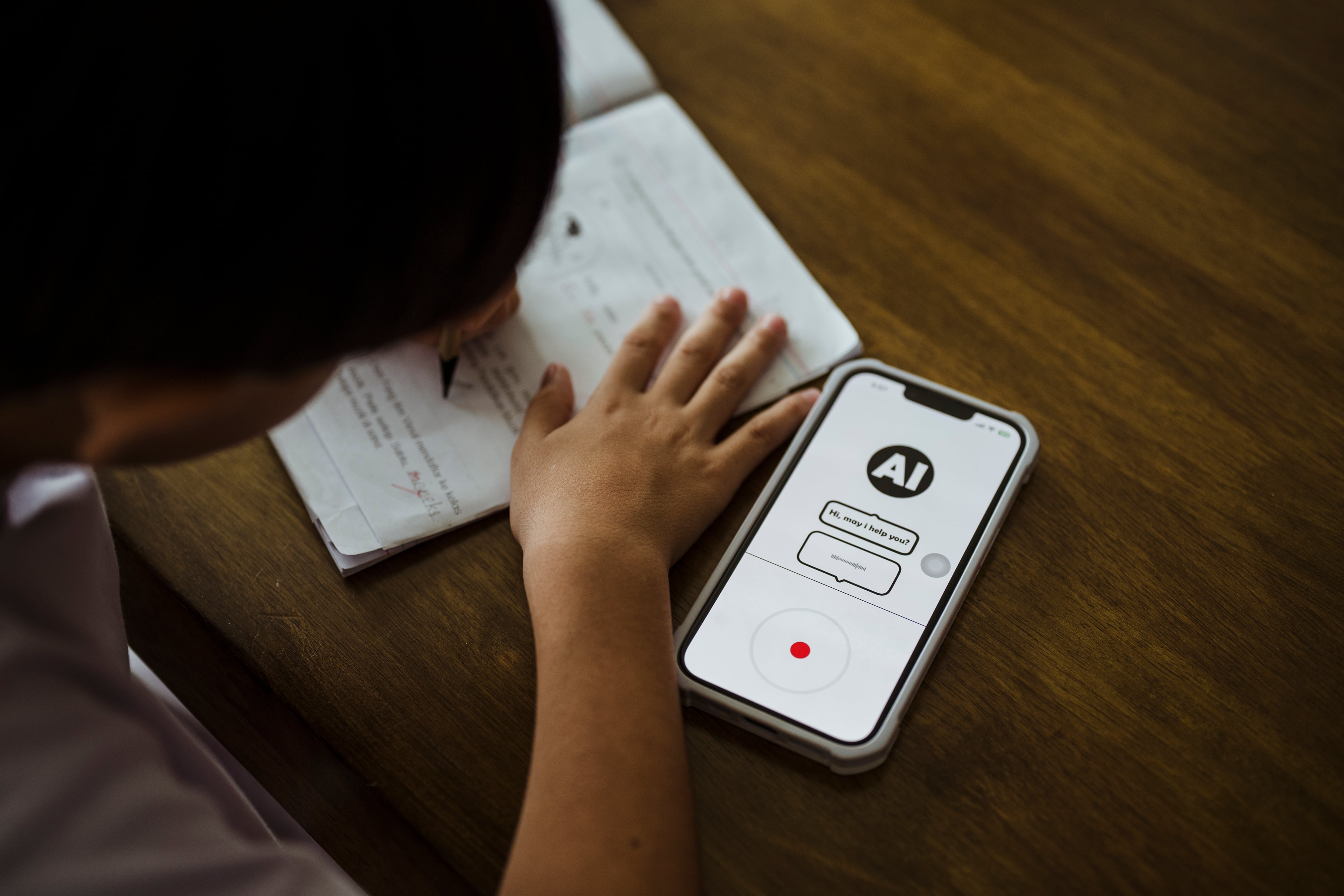 A sudent works on homework with his phone.