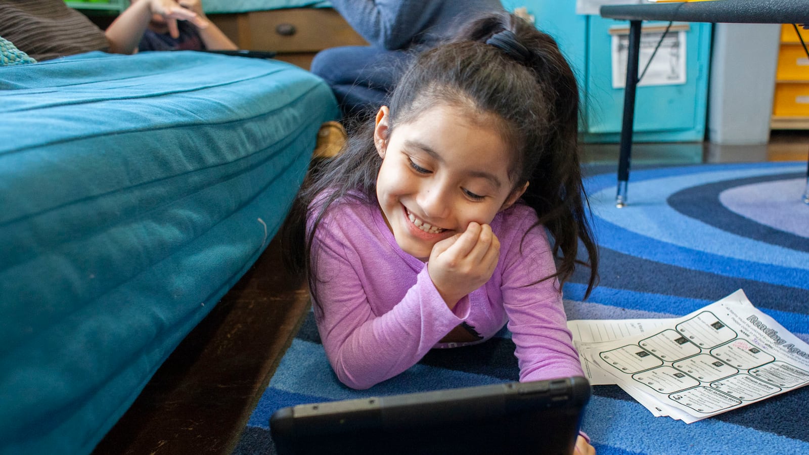 Jaleeah P. delights in getting points for completing a reading lesson on her iPad during class at CICS West Belden in Chicago. Photo by Stacey Rupolo/Chalkbeat  NOTE: Last names not given by school