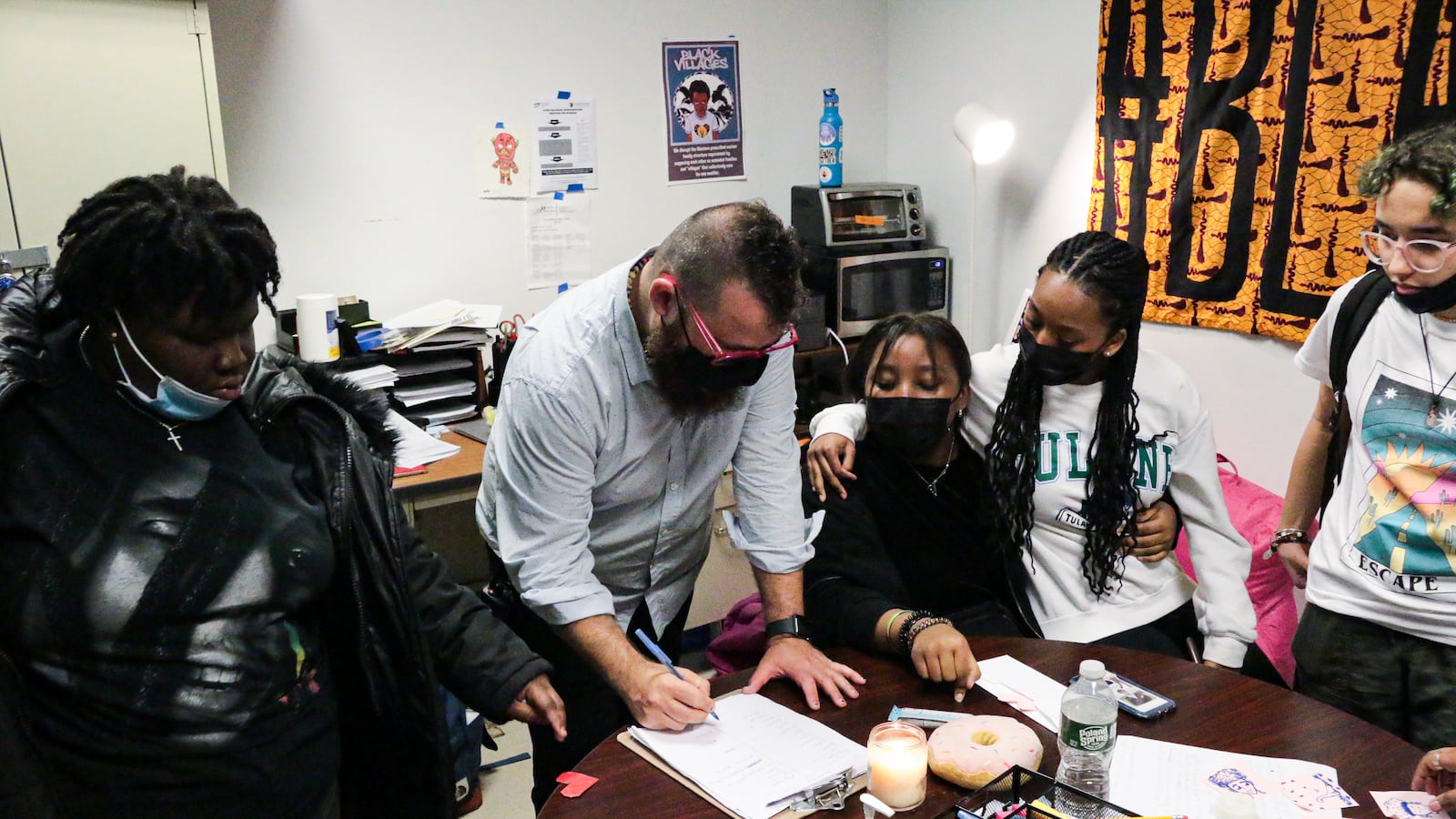 A teacher guides his students through a restorative circle in class.
