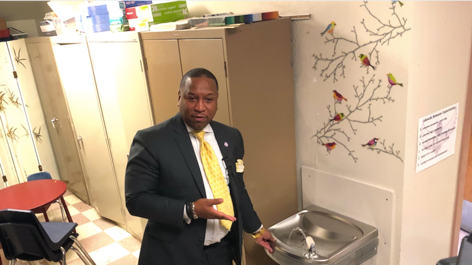 Superintendent Joris Ray prepares to drink from a water fountain that did not test positive for high levels of lead. Three other water fountains at the school were above the state's threshold for safe water, including one at 30 times the limit.
