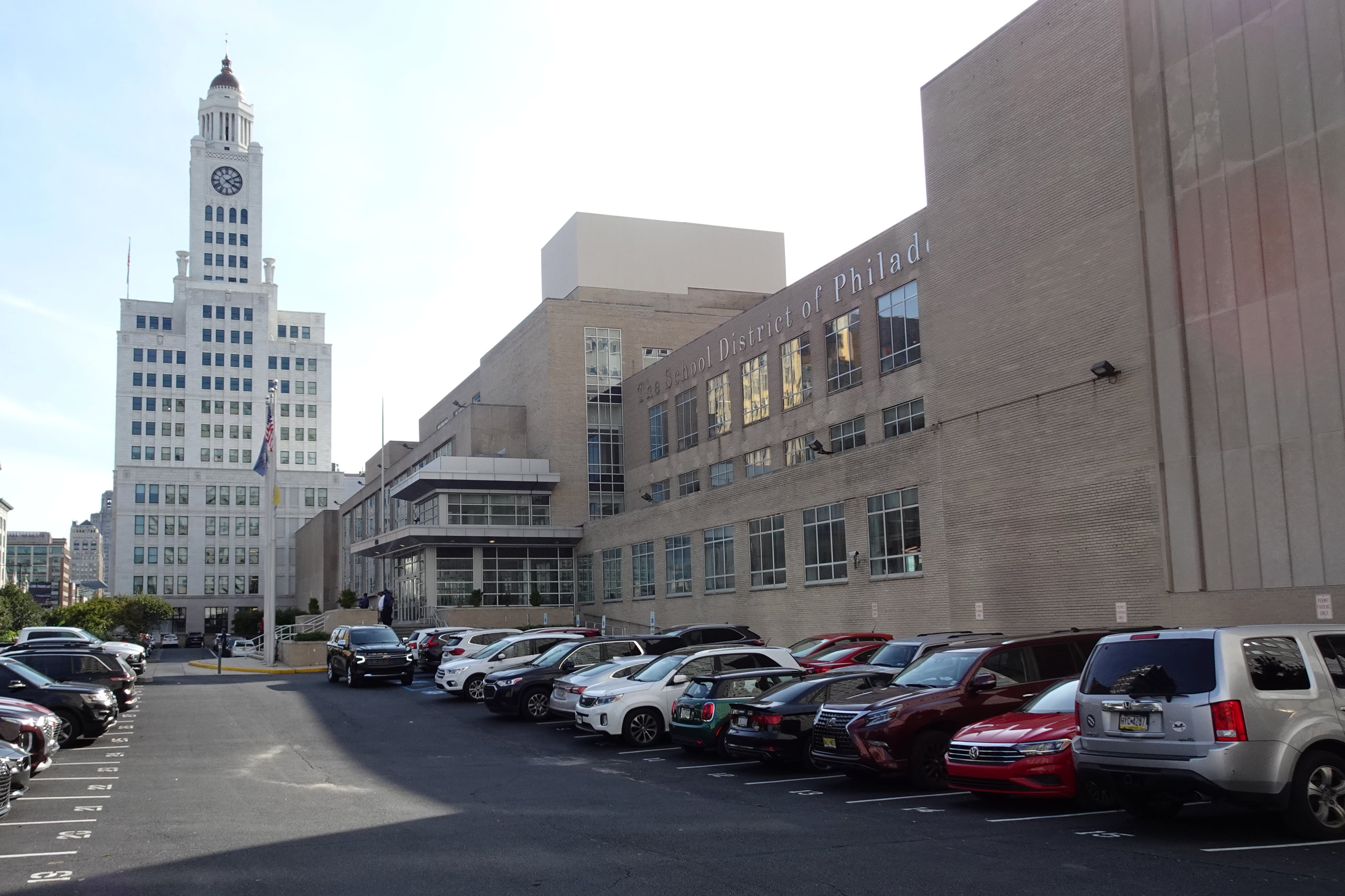 A city street with cars parked outside a building.