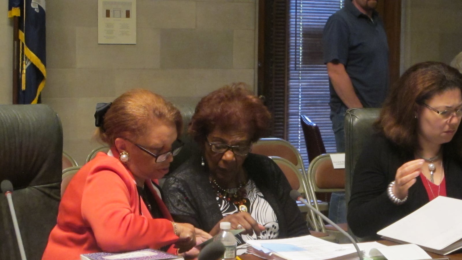 Regent Collins and Regent Johnson engage in a discussion after a Board of Regents meeting in 2016.