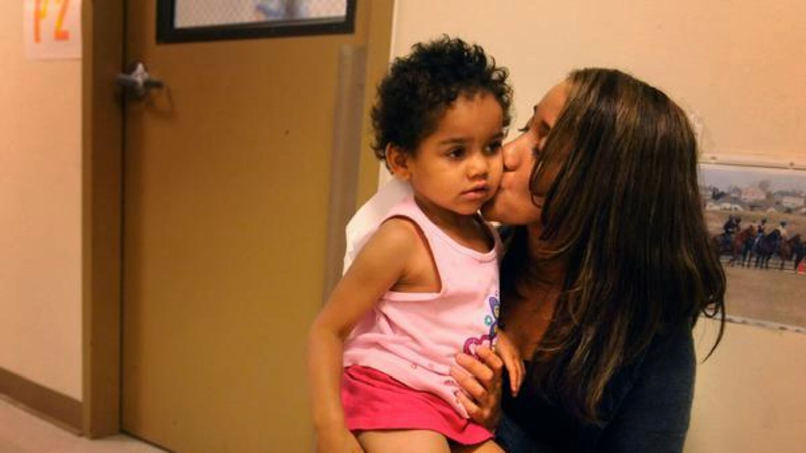 A parent greets her 3-year-old daughter at Edna Oliver Mile High Montessori in 2009. (Karl Gehring, The Denver Post )