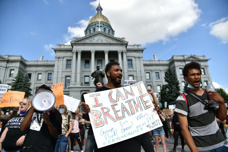 Demonstrators protest the death of George Floyd at the hands of Minneapolis police officers at the Colorado State Capitol in Denver.
