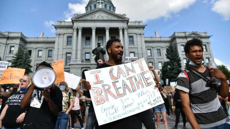Demonstrators protest the death of George Floyd at the hands of Minneapolis police officers at the Colorado State Capitol in Denver.