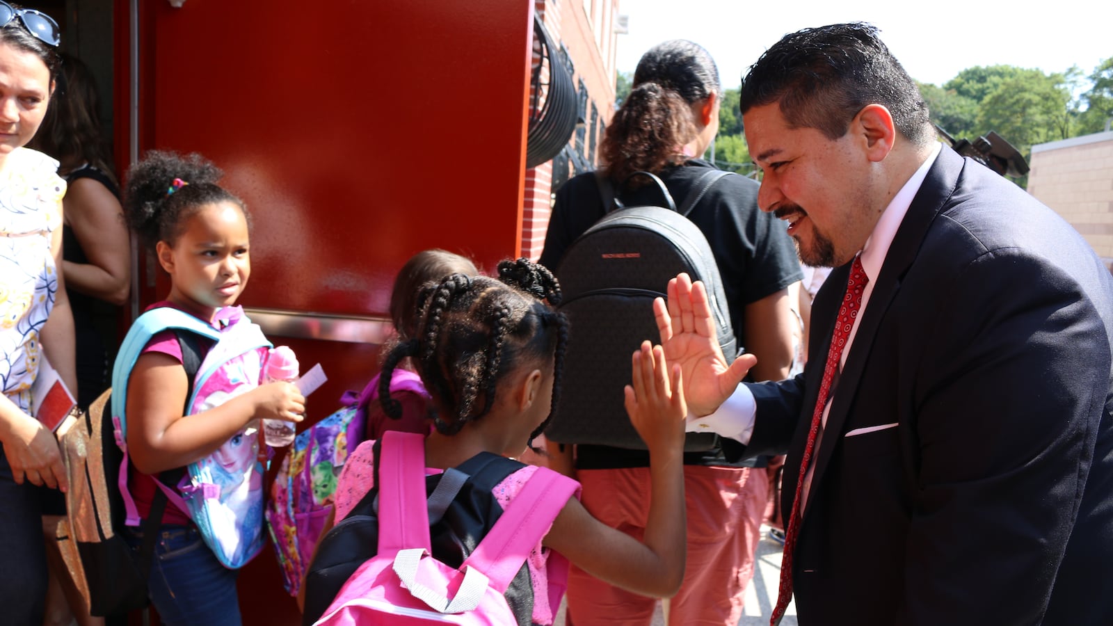 Schools Chancellor Richard Carranza high-fives students at P.S. 78 on Staten Island as they leave after the first day of the 2018-2019 school year.