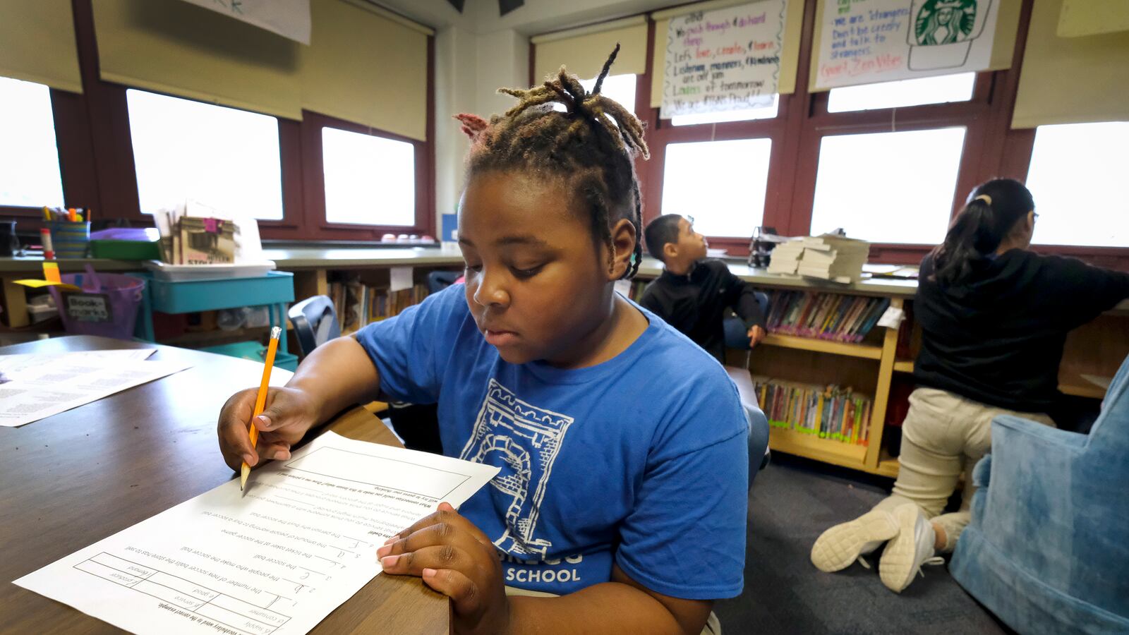 A student with a pencil works at a desk in a classroom at Thomas Gregg Neighborhood School, an elementary school in Indianapolis, Indiana.