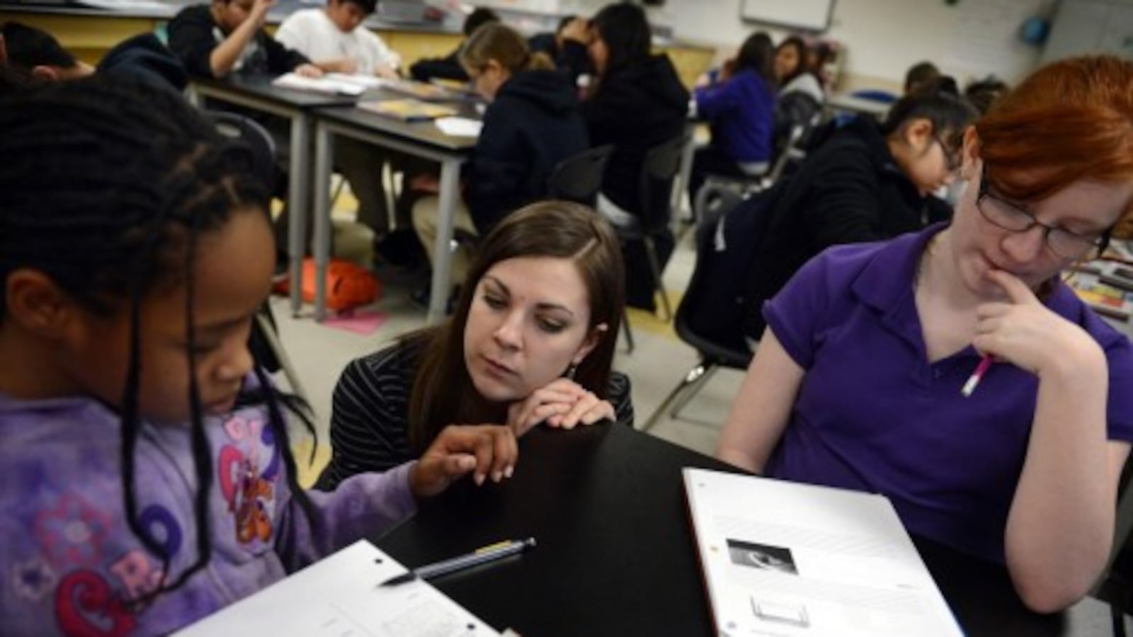 A sixth grade science teacher works with students during Kearney Middle School in 2013 (Denver Post file)