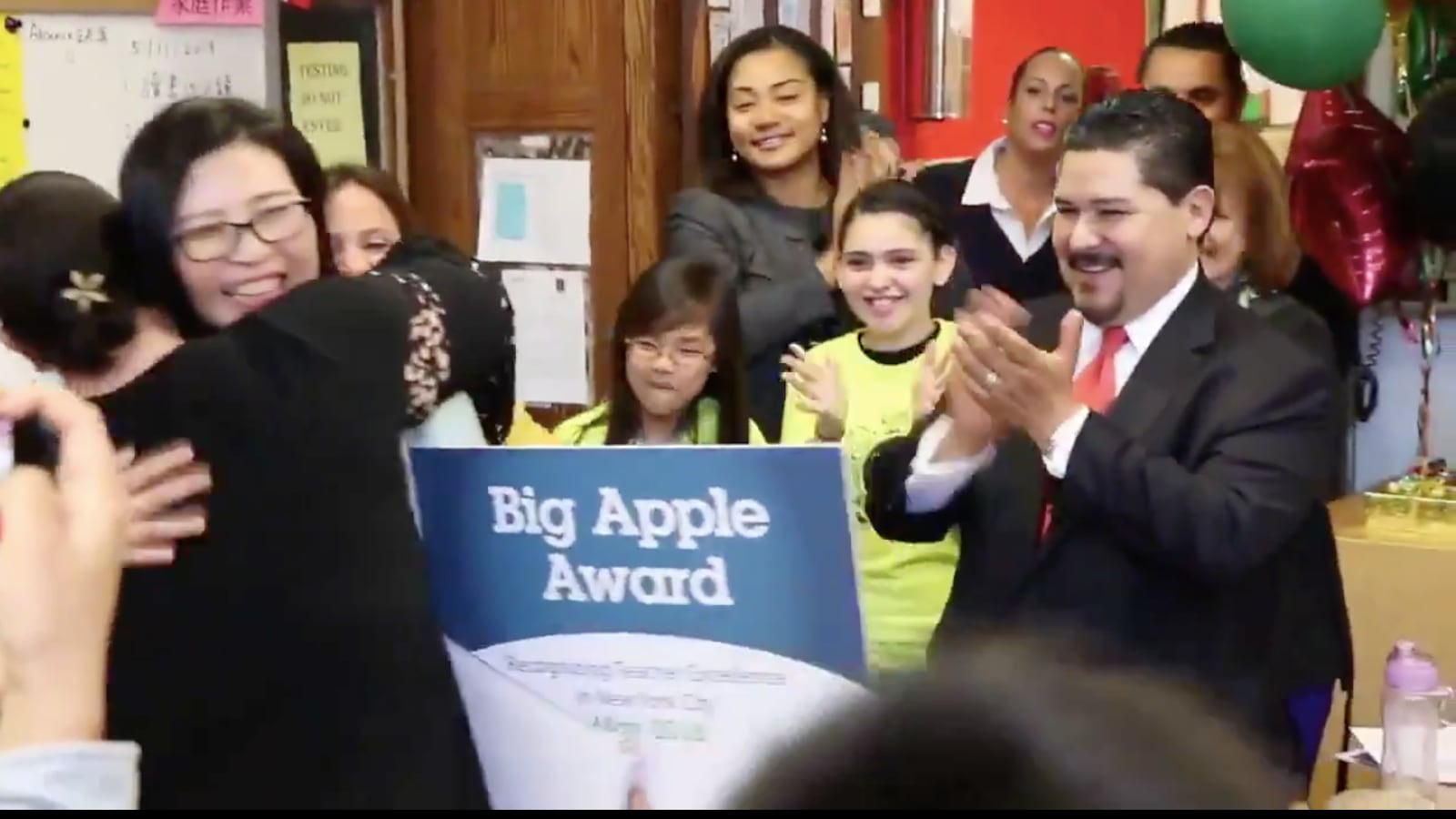 Schools Chancellor Richard Carranza presents a Big Apple Award.