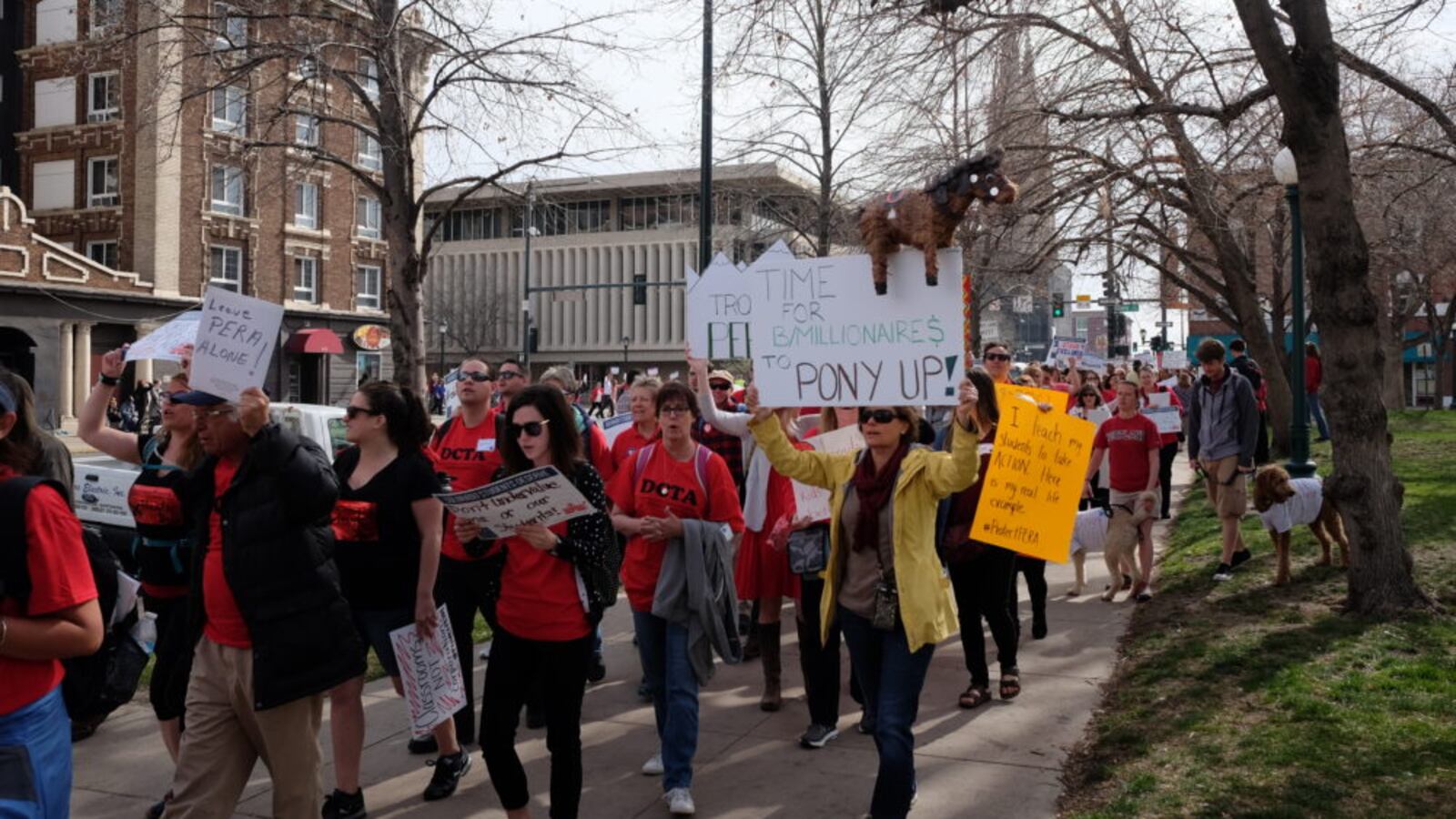 Colorado teachers march around the state Capitol Monday, April 16, to call for more school funding and to protect their retirement benefits. (Erica Meltzer/Chalkbeat)