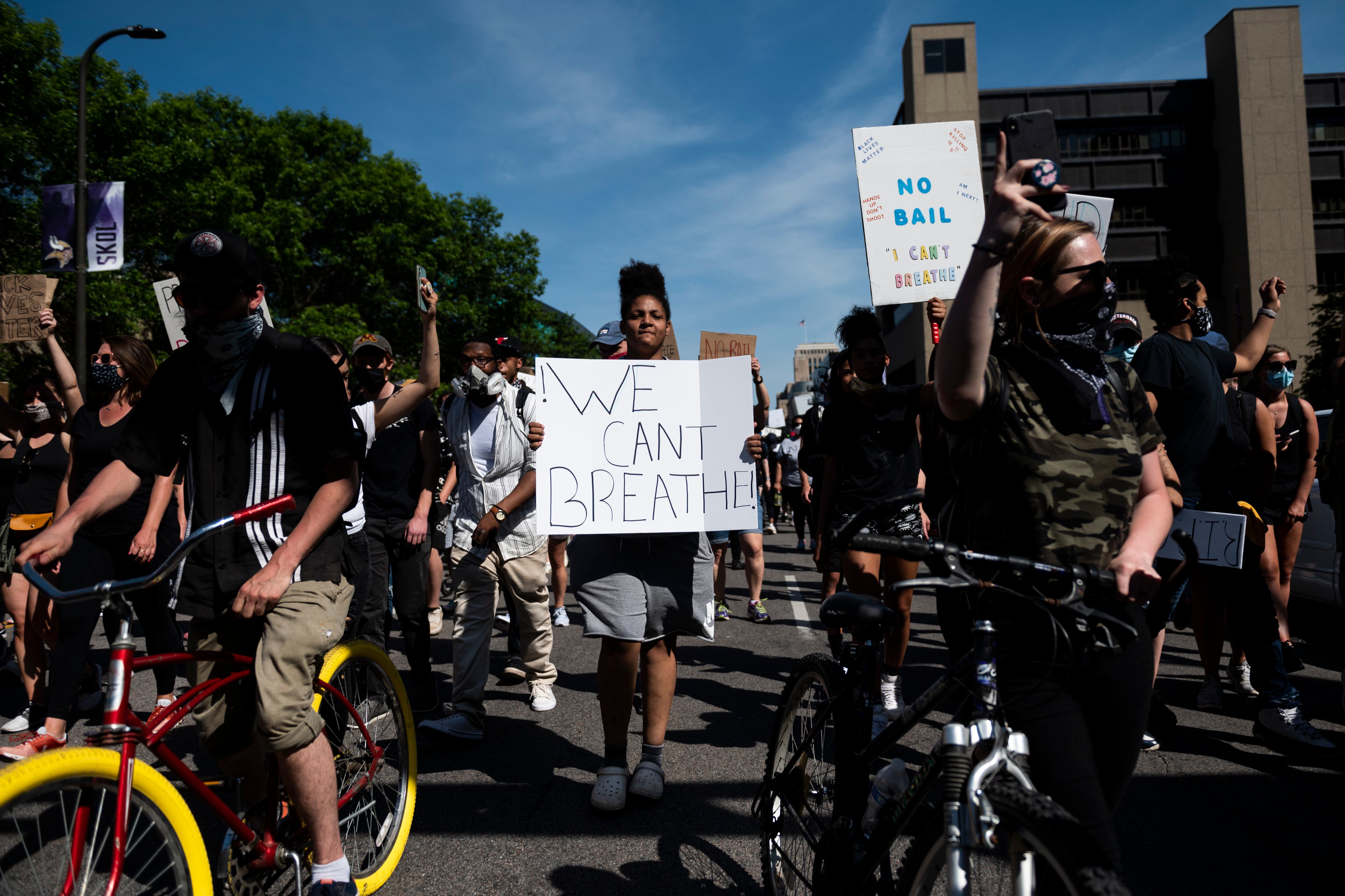 A protestor holds a sign saying “We can’t breathe” in a march in honor of George Floyd in Minneapolis.