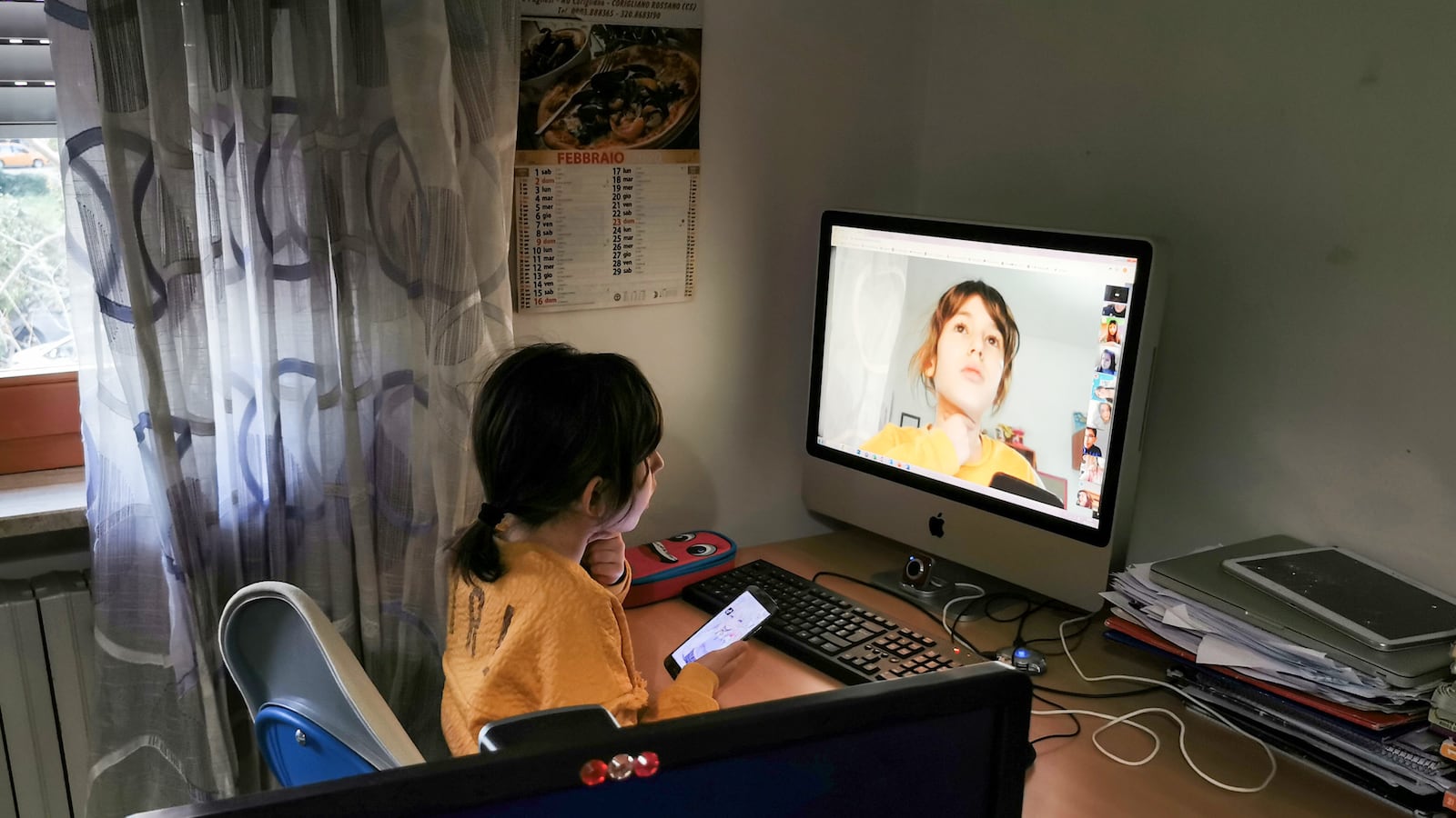 A student in Italy connects with her teacher and classmates online to recover lost instruction while schools are closed due to the new coronavirus.