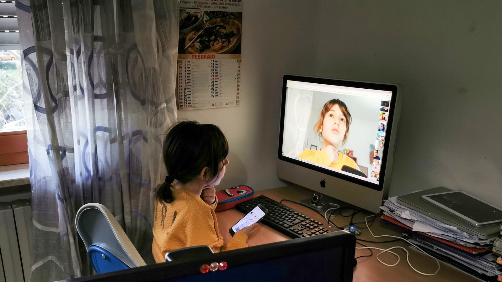 A student in Italy connects with her teacher and classmates online to recover lost instruction while schools are closed due to the new coronavirus.