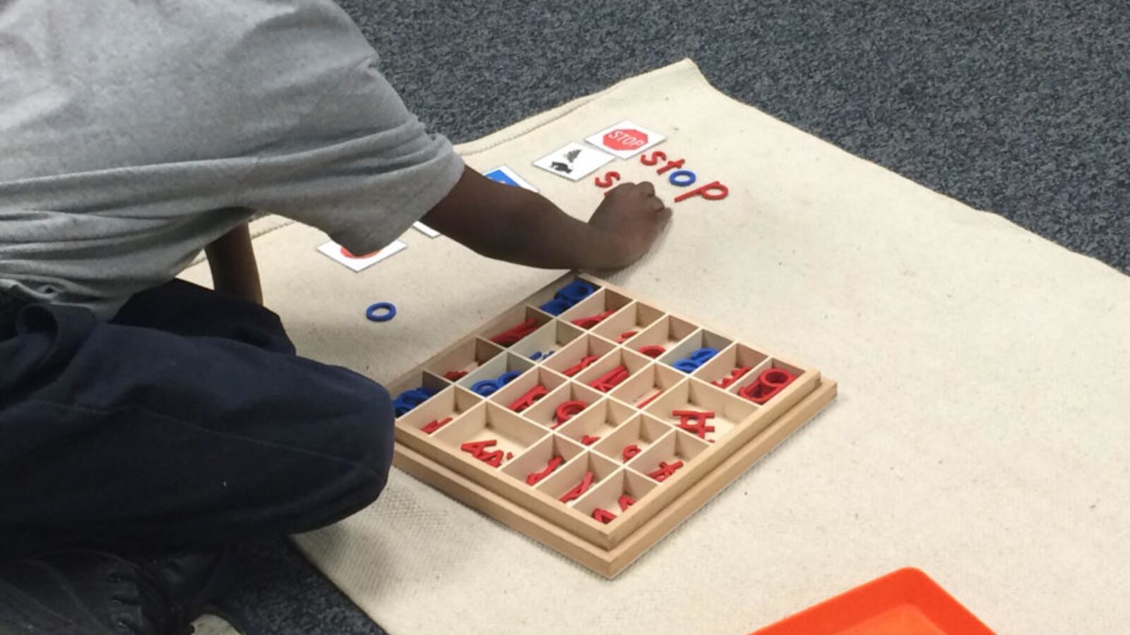 A student at Libertas School of Memphis spells out words next to pictures as part of his independent learning time at the Montessori school in the Frayser community.