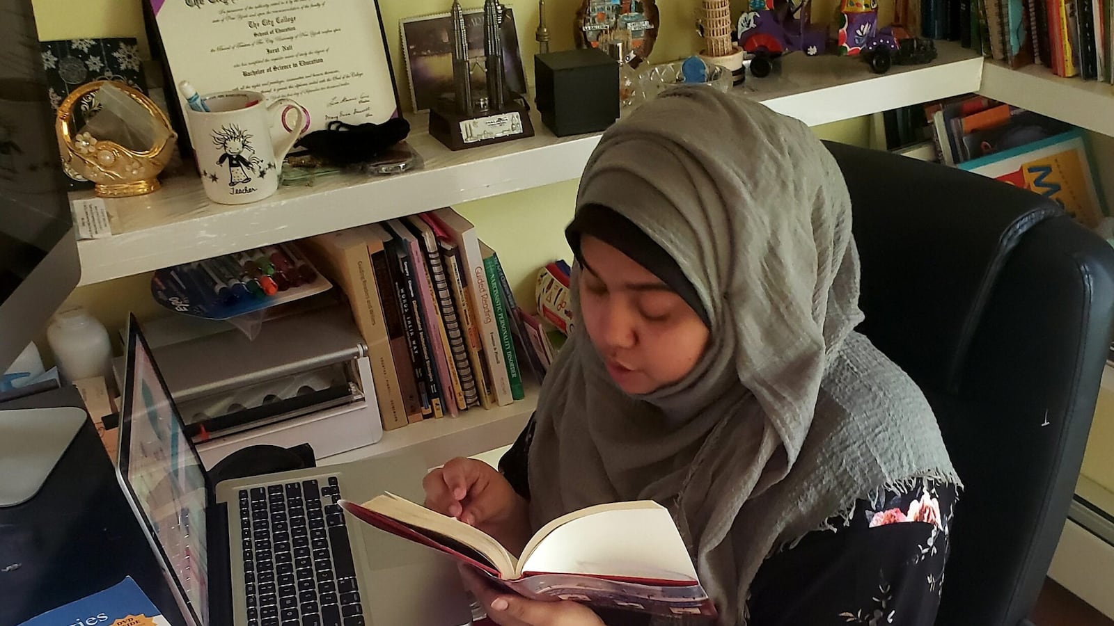 Israt Nali, a third-grade teacher at The Woodside Community School in Queens, virtually reads aloud to her students from her home office. Many of her students are learning English as a new language.