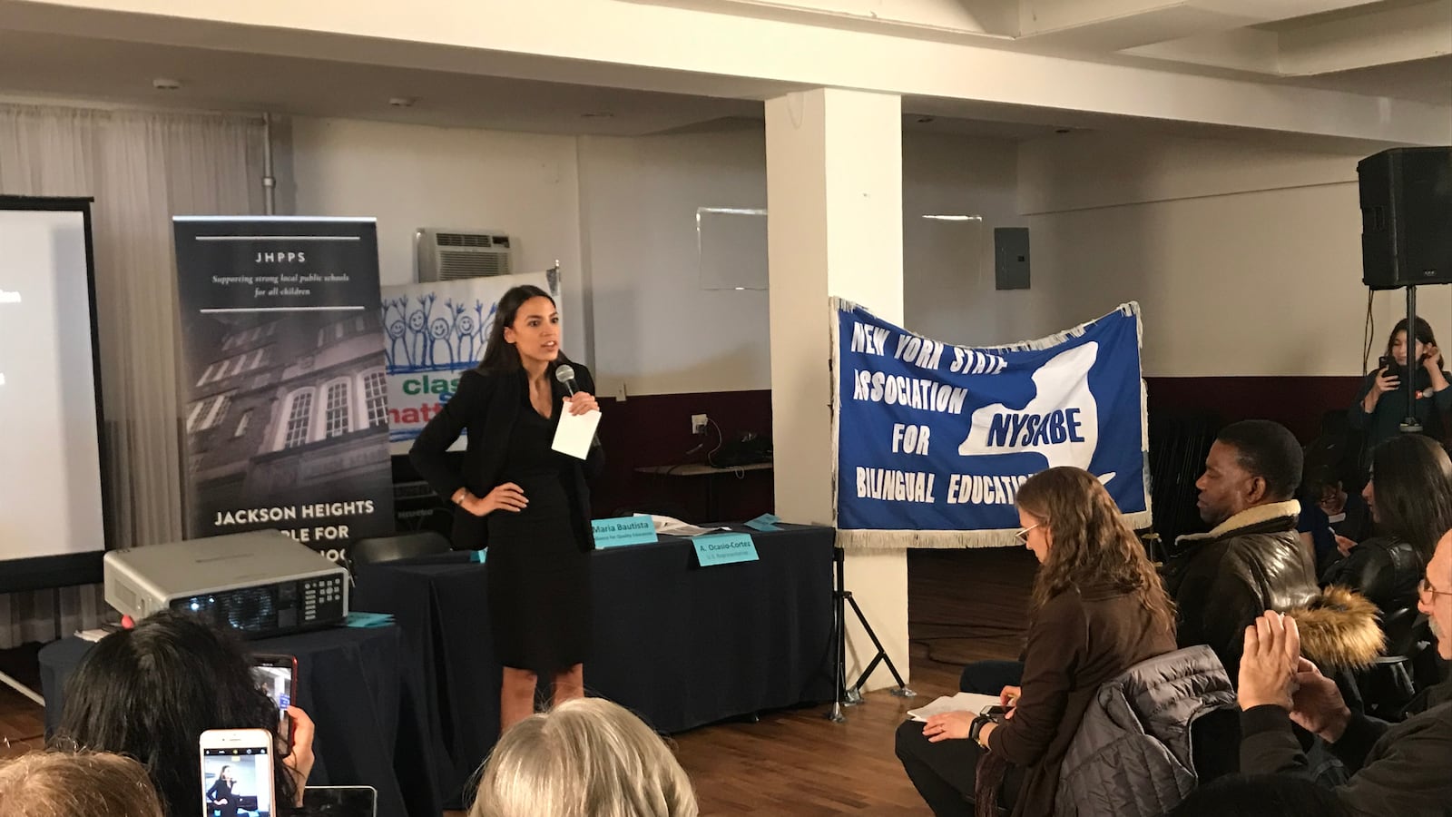 U.S. Rep. Alexandria Ocasio-Cortez talks to a crowd in Jackson Heights during an education town hall.