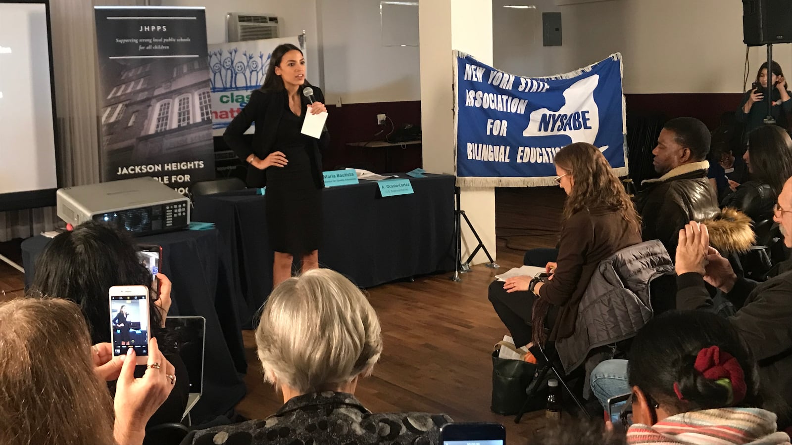 U.S. Rep. Alexandria Ocasio-Cortez talks to a crowd in Jackson Heights during an education town hall.