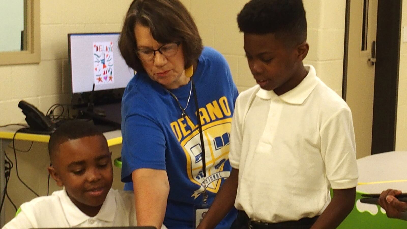Delano Optional Elementary students learn how to use laptops that fold into tablets while playing a get-to-know-you Bingo game on the first day of school.