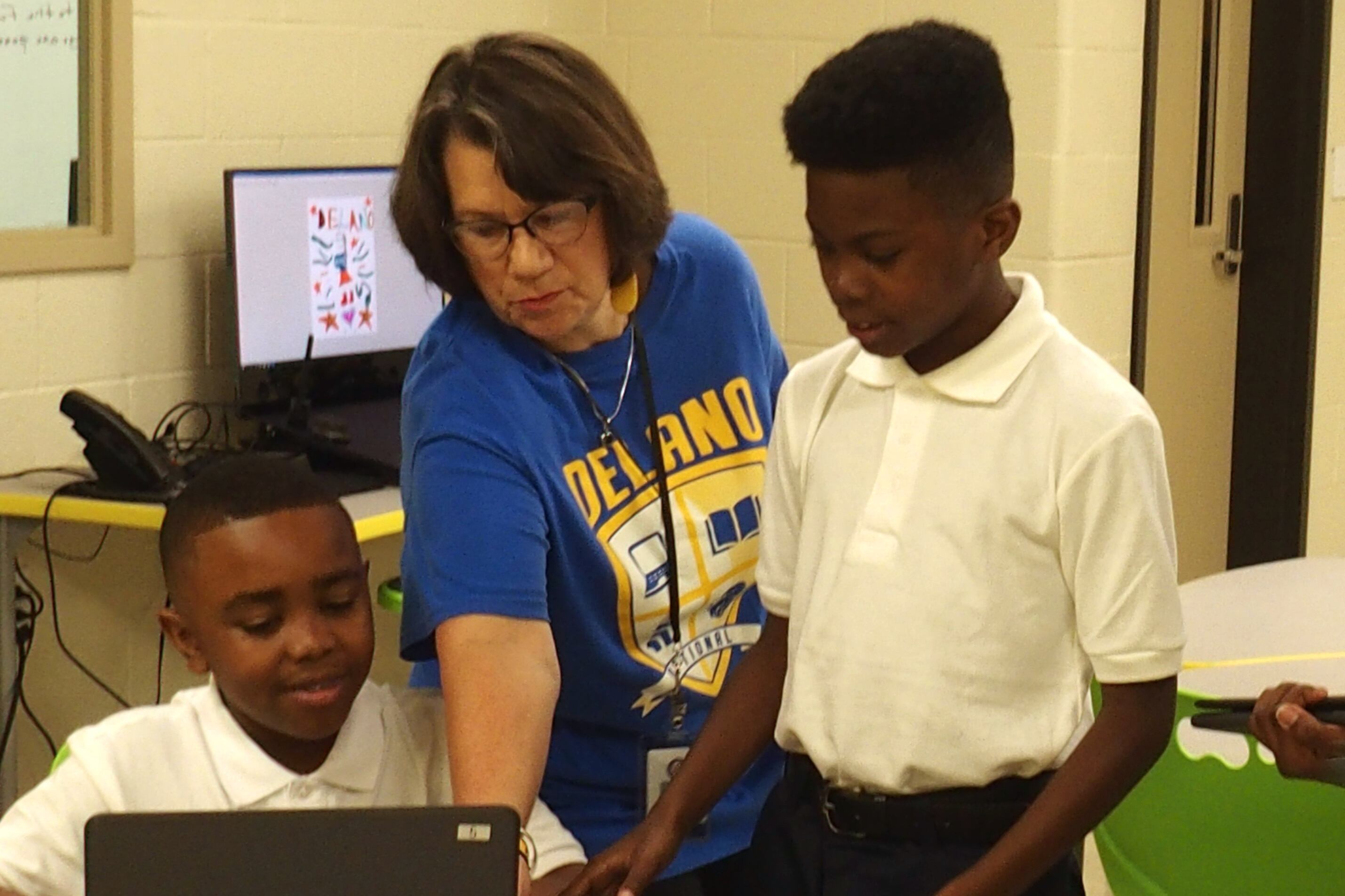 Delano Optional Elementary students learn how to use laptops that fold into tablets while playing a get-to-know-you Bingo game on the first day of school.