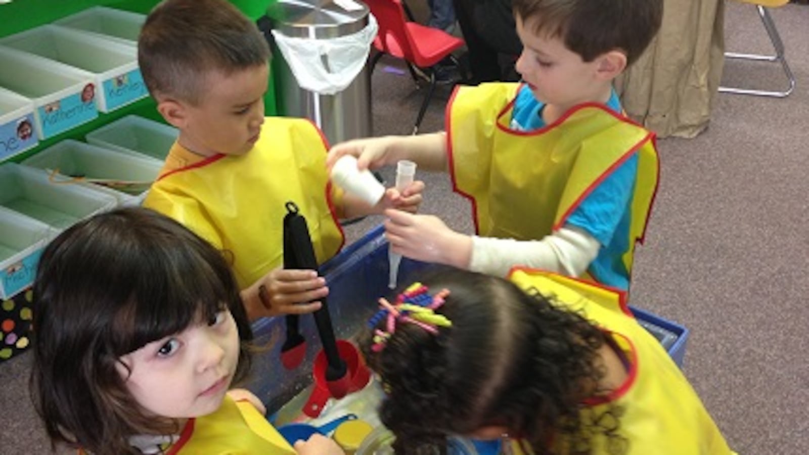 Children play at the water table during free play at Promise Christian Preschool.