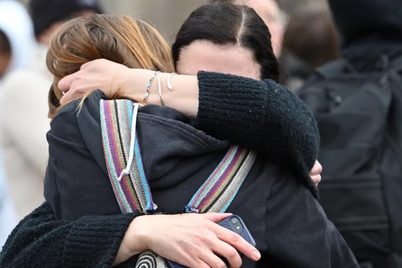 Addison Goetz, 17, is embraced by her mother Jennifer as they leave Denver’s East High School after a shooting there on Wednesday, March 22, 2023.