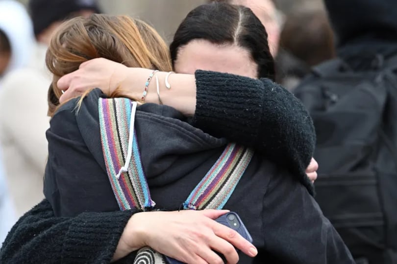 Addison Goetz, 17, is embraced by her mother Jennifer as they leave Denver’s East High School after a shooting there on Wednesday, March 22, 2023.