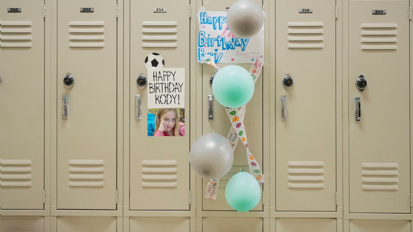 Happy birthday sign and balloons on school locker