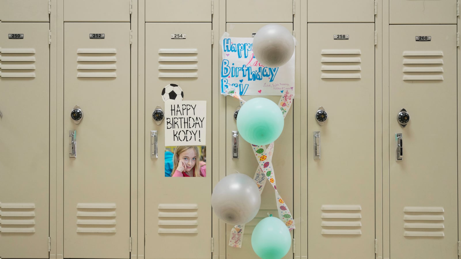 Happy birthday sign and balloons on school locker