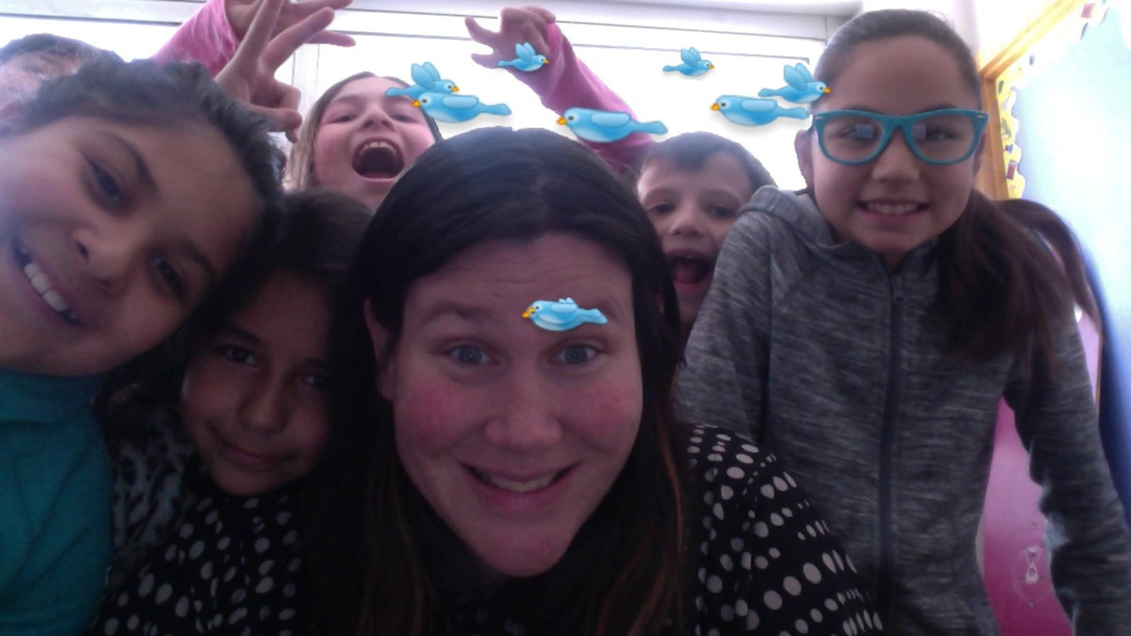 Janine Logar takes a selfie with some of her students using an app that adds cartoons.