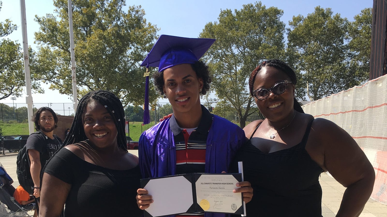 Fernando Garcia on his graduation day is pictured with his former teacher, Dr. Latasha Jones, who told Garcia's mother he had met the requirements to graduate.