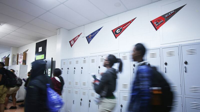 Students walk past lockers at Hillcrest High School, a charter school in Memphis in the Achievement School District, in February 2020. Hillcrest is operated by Green Dot Public Schools.