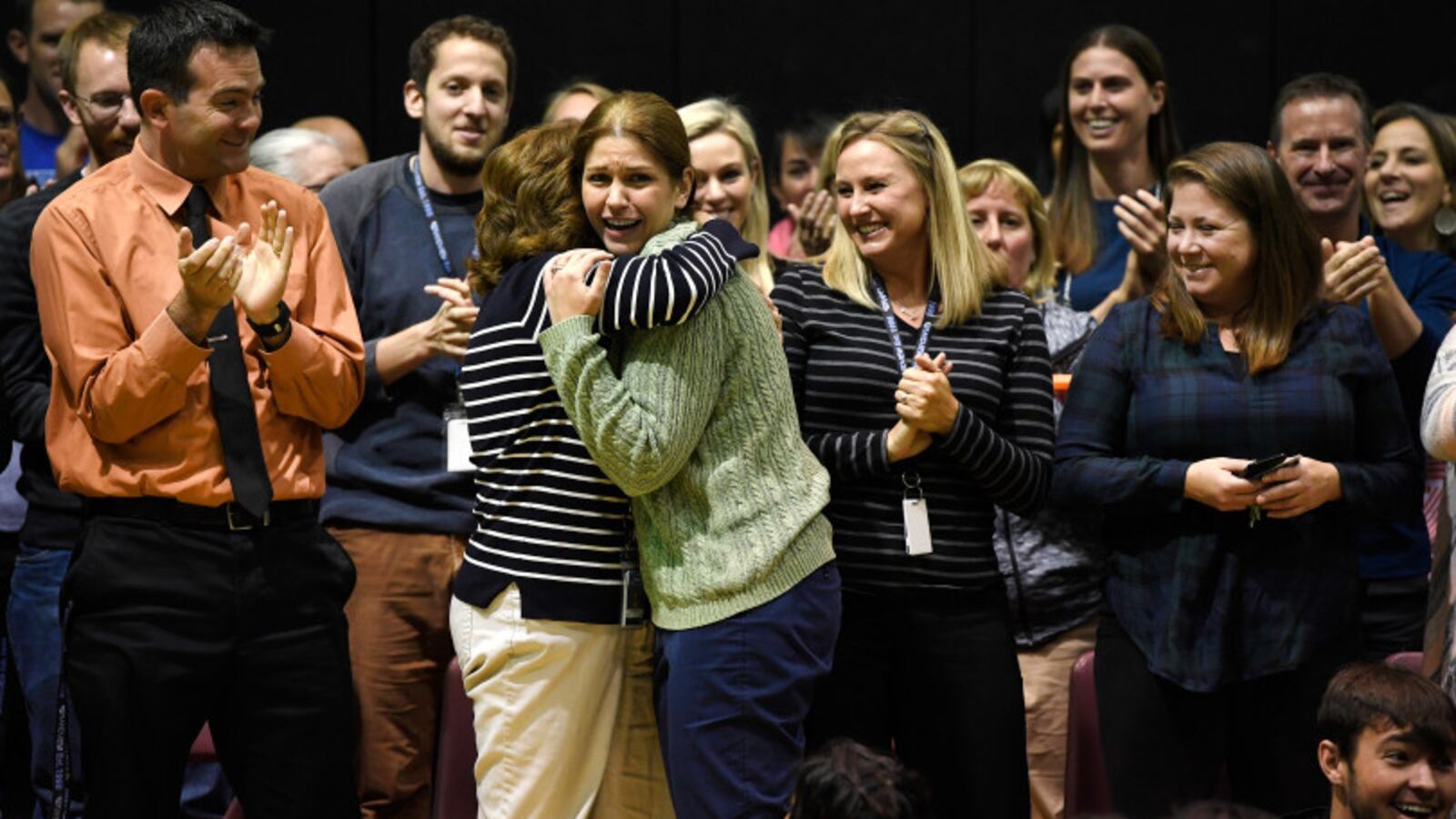 Grandview High School science teacher Lisa Rodgers, being hugged by fellow teachers, is stunned to find out that she is the winner of the 2017-2018 Milken Educator Award at Grandview High School on October 31, 2017. (Photo by Helen H. Richardson, The Denver Post)