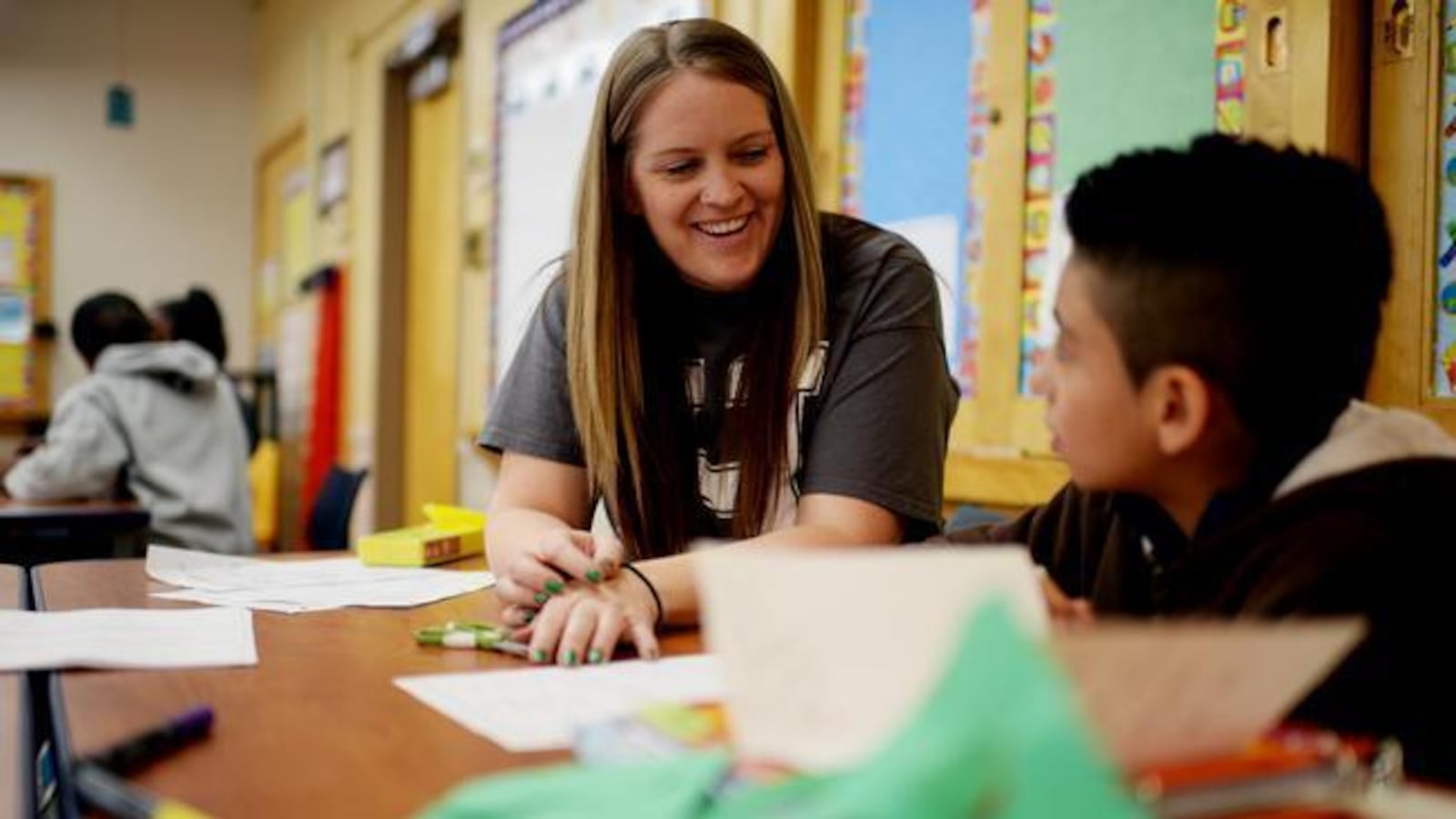 Elizabeth Sanchez, a math teacher at Denver's Hill Campus of Arts and Sciences, checks the homework of a student in this 2014 file photo.