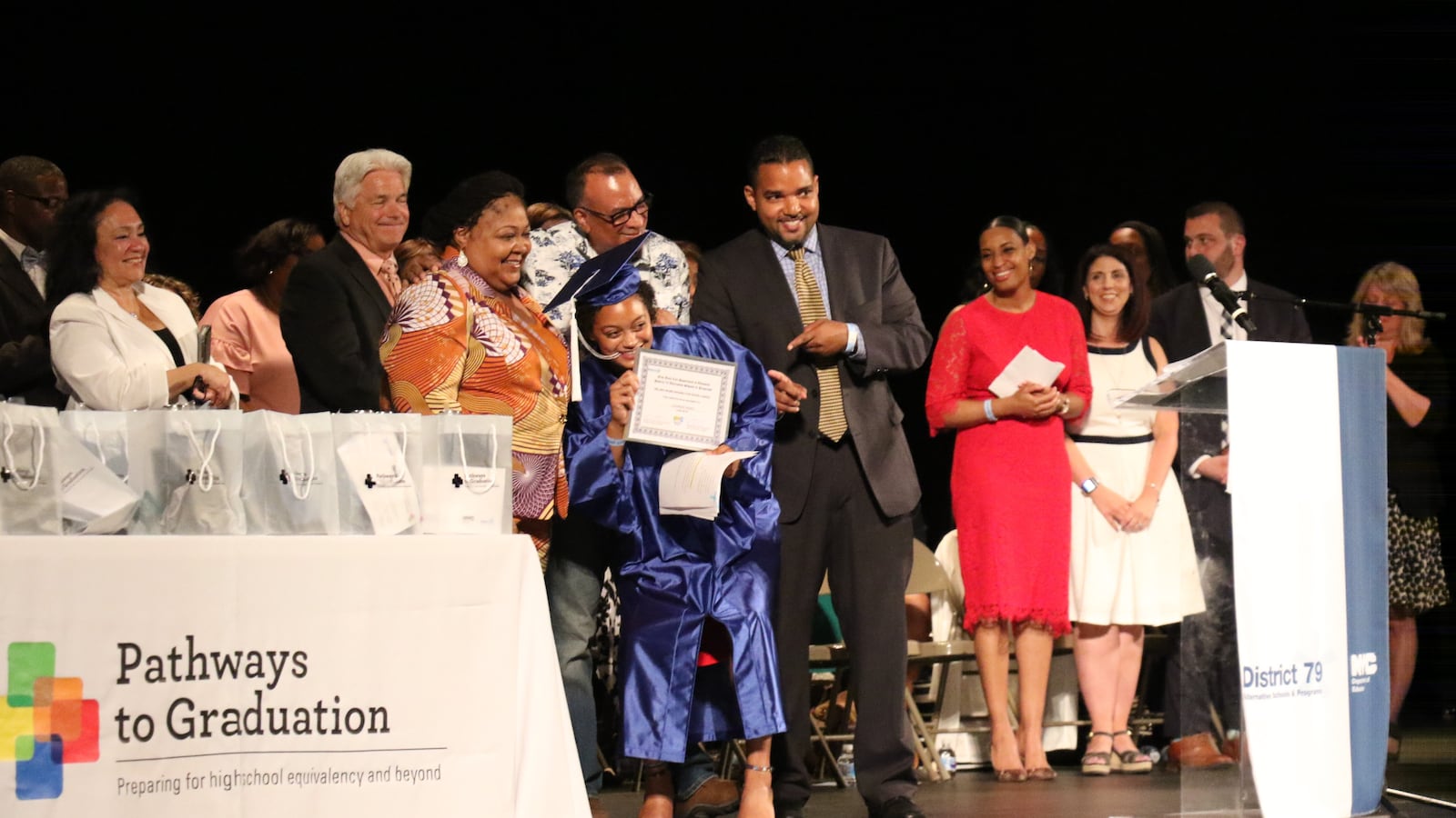 Jasmine Byrd receives an award for excellence after giving a speech to her fellow graduates.