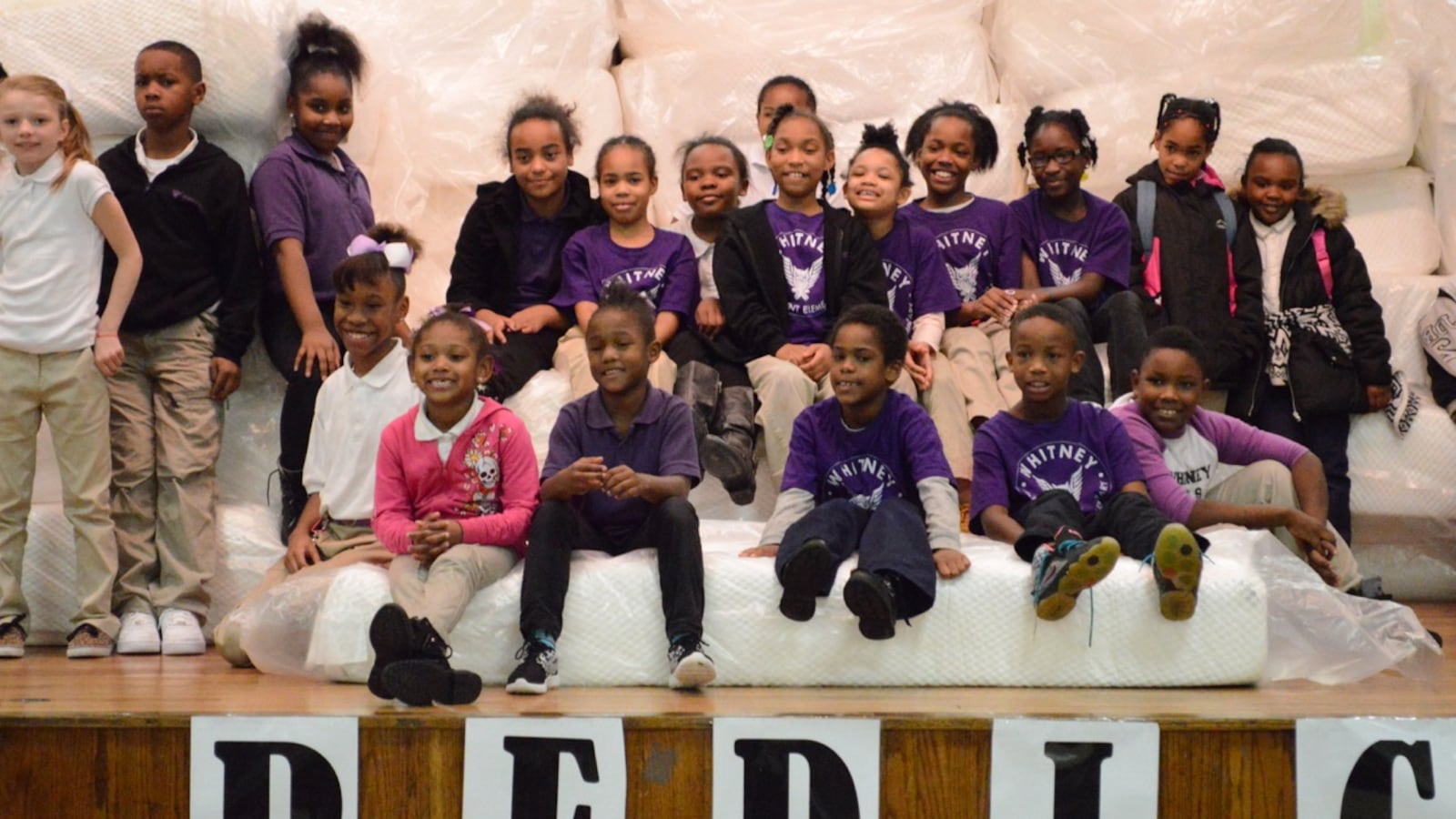 Students at Whitney Achievement Elementary School receive their new mattresses during an assembly at the Memphis school.