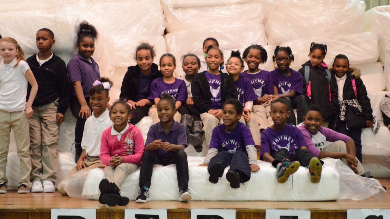 Students at Whitney Achievement Elementary School receive their new mattresses during an assembly at the Memphis school.