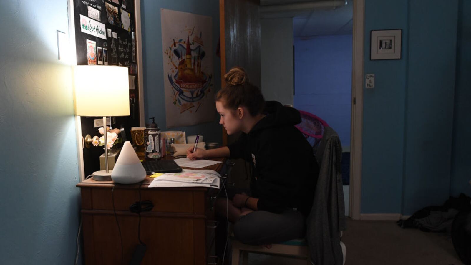 LAKEWOOD, COLORADO - MARCH 17: Fifteen-year-old Campbell Preston, a high school freshman in Jeffco Public Schools, works on doing her first day of online learning in her room at her family's home on March 17, 2020 in Lakewood, Colorado. (Photo by  RJ Sangosti/MediaNews Group/The Denver Post via Getty Images)